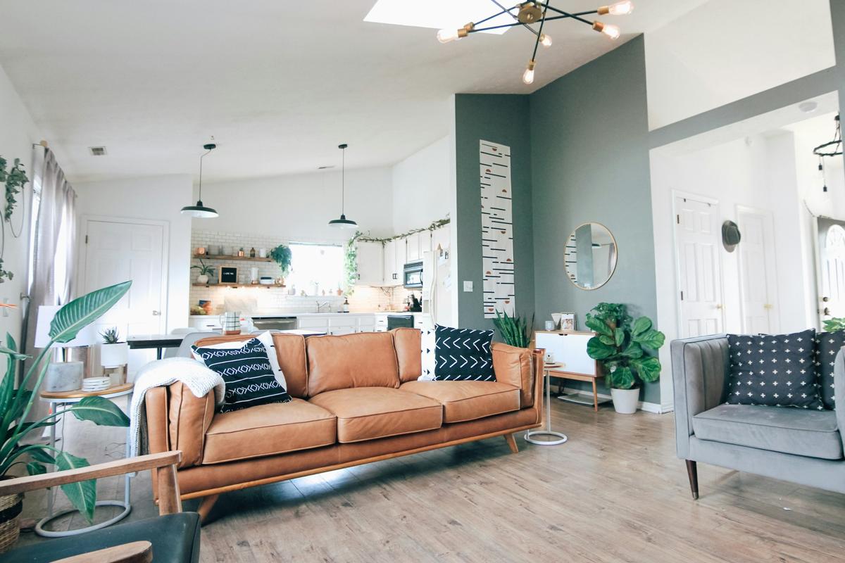 A bright, tidy living room with a sofa and armchair