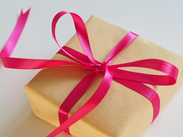A gift box tied with a pink ribbon